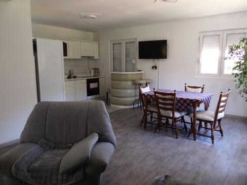 a living room with a couch and a table and a kitchen at Kuca Aura in Višegrad
