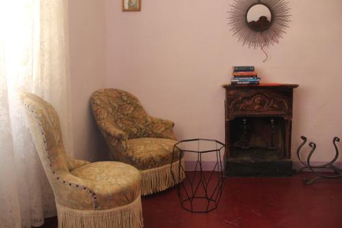 a living room with two chairs and a mirror at Friciulin - guest house in Lesegno