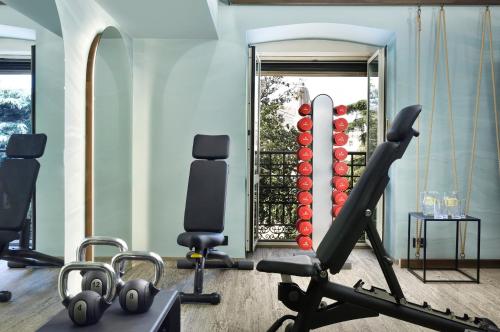 a fitness room with a gym with a treadmill at Grand Hotel Savoia in Genova