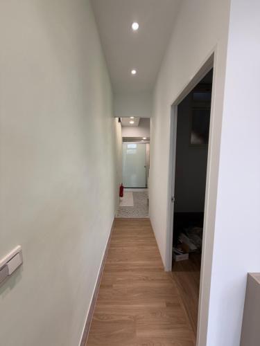 a hallway with white walls and a wooden floor at Living in the mountains in San-wan