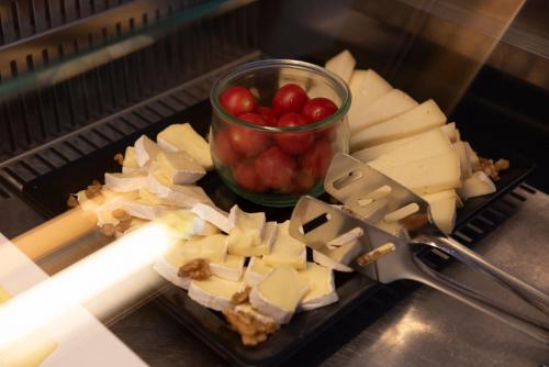 a plate of cheese and a bowl of tomatoes at Hotel Garden Lido in Loano