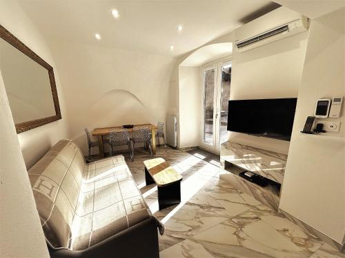 a living room with a couch and a table at U TIGRU - Luxe au cœur d'un village du Cap Corse in Luri