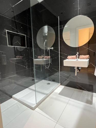 a bathroom with a sink and a mirror at Bayside A Apartments in St Julian's