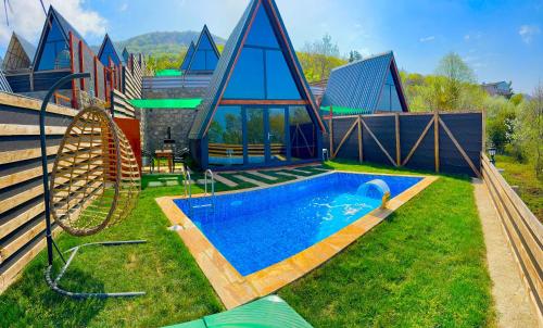 a house with a swimming pool and a playground at Amasra Blue Horizon Bungalow in Eskiömerler