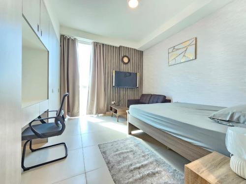 a hotel room with a bed and a tv at Studio KCA - 609 in Abu Dhabi