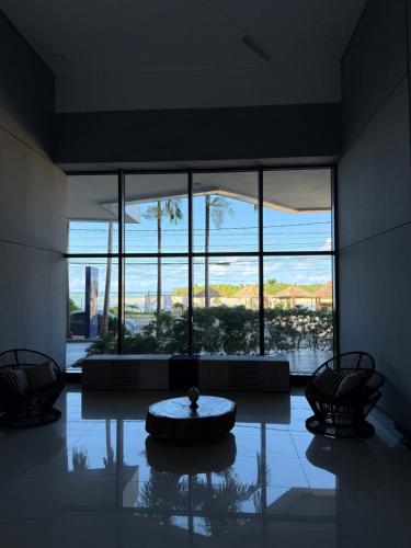 a large room with a large window with a table in the middle at Beach Flats Barra Home Stay By Flatbpaiva in Recife