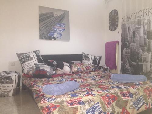 a woman laying on a bed in a bedroom at Ionias Apartment in Heraklio