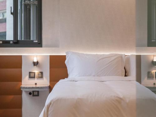 Postel nebo postele na pokoji v ubytování LIVIN Hotel
