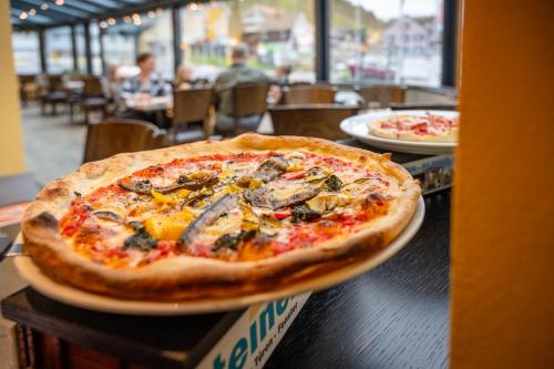 a pizza sitting on top of a table at Hotel- Restaurant Krone in Urnäsch