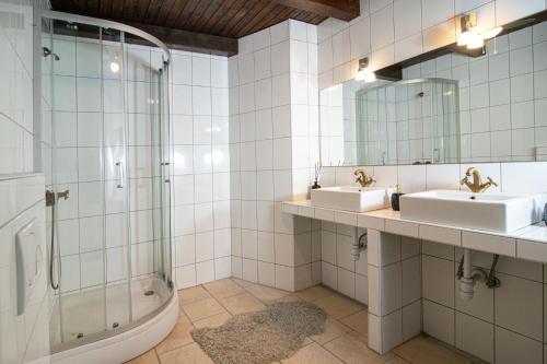 a bathroom with two sinks and a shower at Paradise cottage in Vinišće
