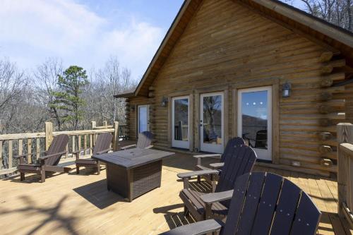 a deck with chairs and a table on a cabin at Echo Mountain in Fairview