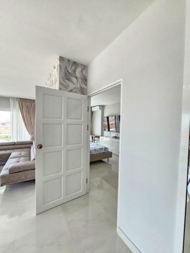 a white door in a room with a bedroom at View Talay6 by Blue Ocean Suite in Pattaya Central