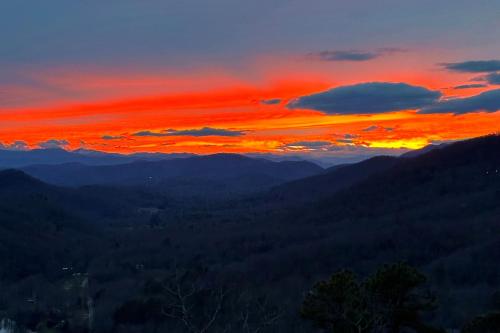 a sunset in the mountains with a red sky at Echo Mountain in Fairview