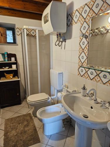 a bathroom with a toilet and a sink at Casa DAFNE in Lipari