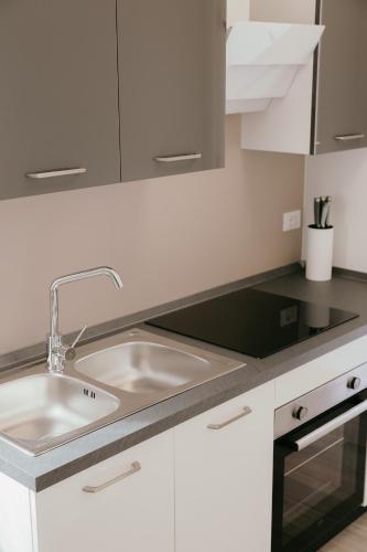 a kitchen with a sink and white cabinets at Tenuta delle Radici in Giavera del Montello