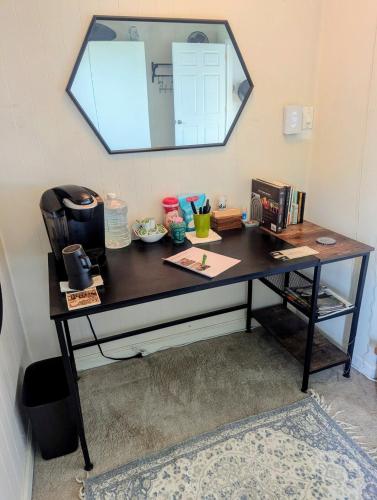 a desk in a room with a mirror on the wall at The Zen Den in Hellertown