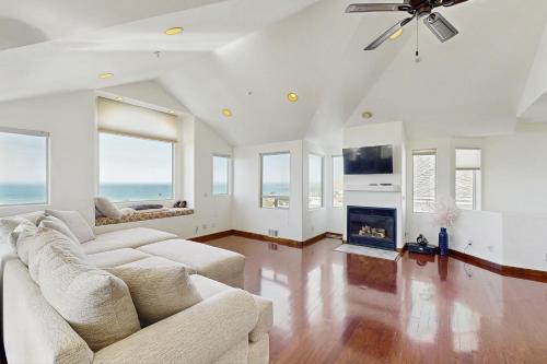 a living room with a couch and a fireplace at Park Avenue Beach Life in Cayucos