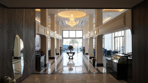 a hallway of a building with a chandelier at The bright View hotel in Al Khafji