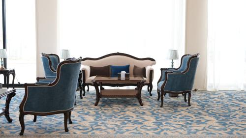 a living room with a couch and two chairs at The bright View hotel in Al Khafji
