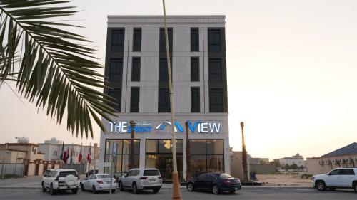 a building with cars parked in front of it at The bright View hotel in Al Khafji