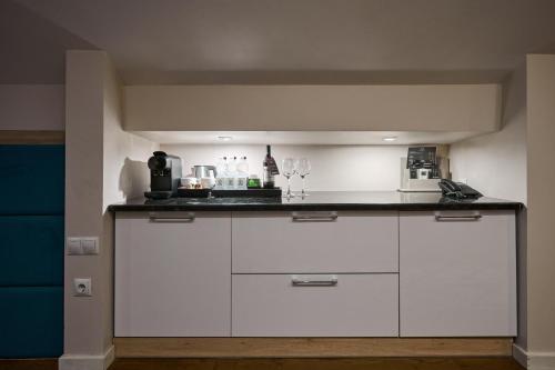 a kitchen with white cabinets and a counter top at F&B Spa Resort (ex. Fomich Hotel) in Bukovel