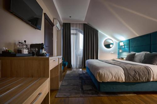 a hotel room with a bed and a television at F&B Spa Resort (ex. Fomich Hotel) in Bukovel