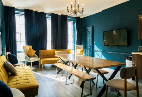 a living room with a table and a couch at Tron Kirk Residence in Edinburgh
