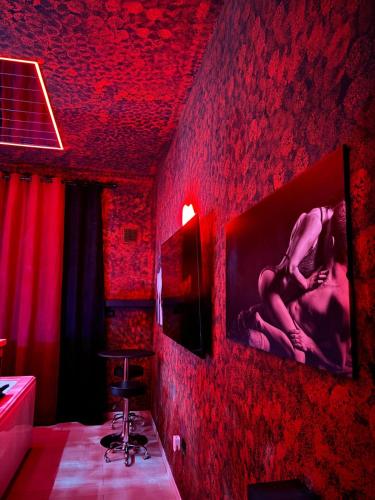 a red room with a bathroom with a red wall at L'H LION's RED SUITE in Castrovillari