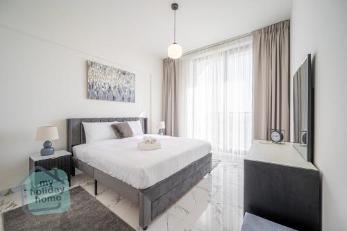 a bedroom with a bed and a large window at Private Beach 1BR-Yacht Club-Work Space-Pool-Gym in Ras al Khaimah