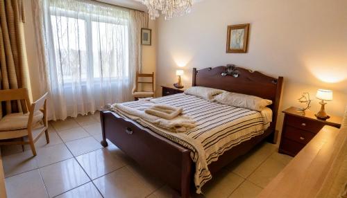 a bedroom with a bed and a chair and a window at Casa Salinella in Torre Nubia
