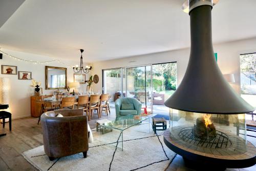 un salon avec cheminée et une salle à manger dans l'établissement Villa Armor - 400m de la mer -, à Larmor-Plage