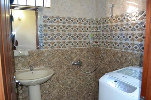 a bathroom with a sink and a toilet and a shower at RS VILLA private apartment with pool and free wifi in Flic-en-Flac
