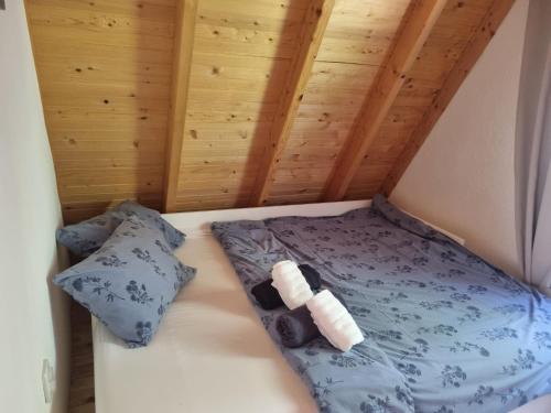 a bed in a room with two pillows at Sara in Malo Polje