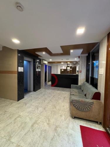 a lobby with a couch in the middle of a building at Crown Inn in Bengaluru