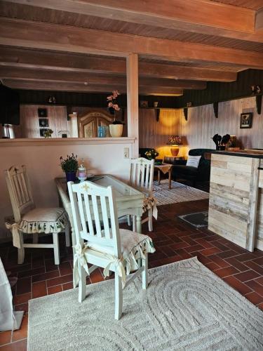 a living room with a table and two chairs at FeWo Südfrankreich in Neue Scheune