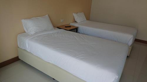 Postel nebo postele na pokoji v ubytování หอมสวัสดิ์วิลเลจ รีสร์อท