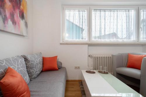 a living room with a couch and a table at Hotel Garni Vitamari in Wasserburg am Bodensee
