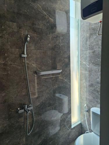 a shower in a bathroom with a toilet at Villa Srikandi Caldera D5 in Tlekung