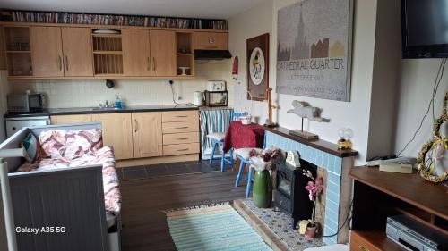 a kitchen and a living room with a table at Artisthostel Letterkenny in Letterkenny