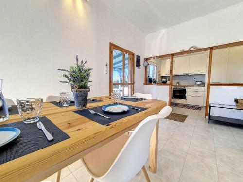 a kitchen and dining room with a wooden table and chairs at Hydra Bay Seaside Villa with Pool in Thermisia