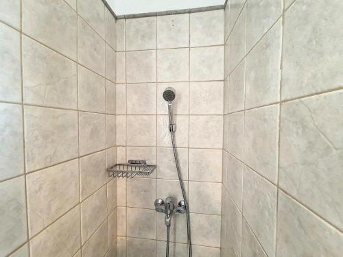 a shower with a shower head in a bathroom at Seaview Villa with Pool for 6 in Porto Heli