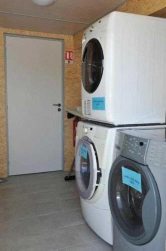 a washing machine with a microwave on top of it at Camping 4 étoiles - Piscine - ccb0bif in Apremont