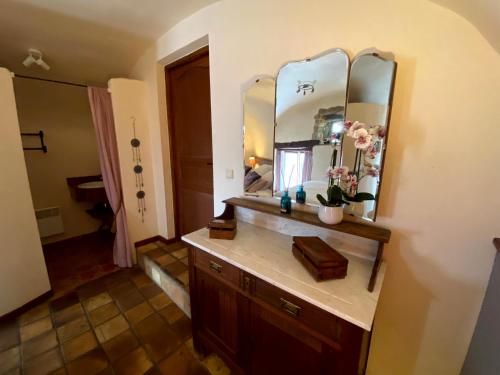 a bathroom with a sink and a mirror at B&B Maison des Etoiles Chambre d'hôtes Adult Only in Verrières