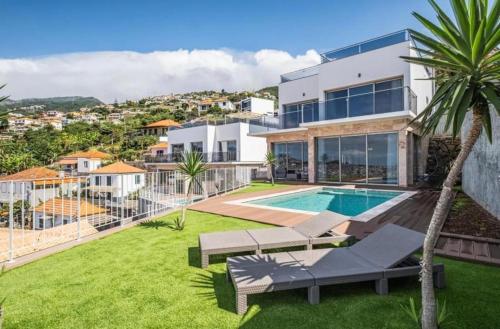 an image of a house with a swimming pool at Villa Amazing View Funchal - Lux & Pool in Funchal