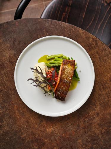 a white plate of food on a table at Hotel Carmel  in Haifa