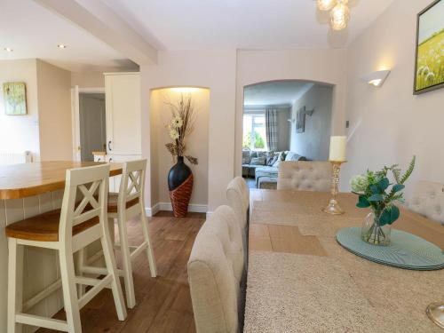 a kitchen and living room with a table and chairs at 6 Barleycroft in Great Yarmouth