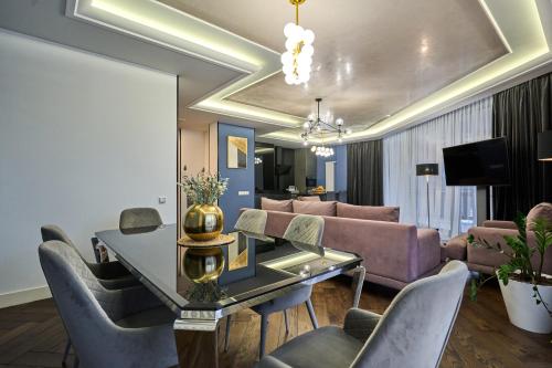 a living room with a couch and a table and chairs at F&B Spa Resort (ex. Fomich Hotel) in Bukovel