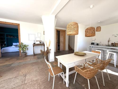 a kitchen and dining room with a white table and chairs at Domaine la Clausade in Mauguio