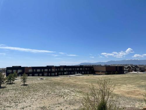 a large building with a field in front of it at Clear Estate Spacious Retreat with BBQ & Views in Pikeview