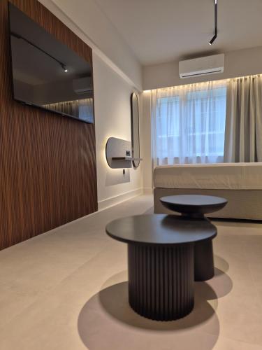 a living room with a table and a couch at Shape Suites Athens in Athens